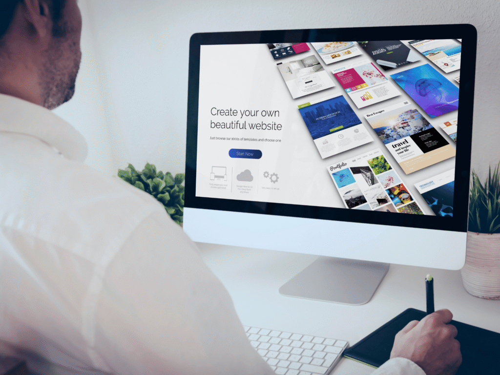 A man sitting at a desk using a computer to create a AI website , with text displayed on the screen.