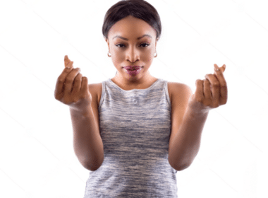 A woman holds up two fingers, symbolizing victory or peace, promoting the idea of getting paid for exercising.