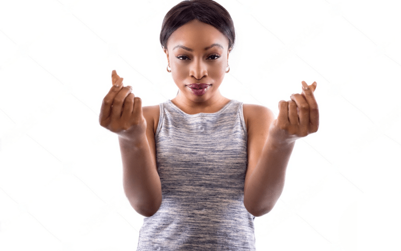 A woman holds up two fingers, symbolizing victory or peace, promoting the idea of getting paid for exercising.