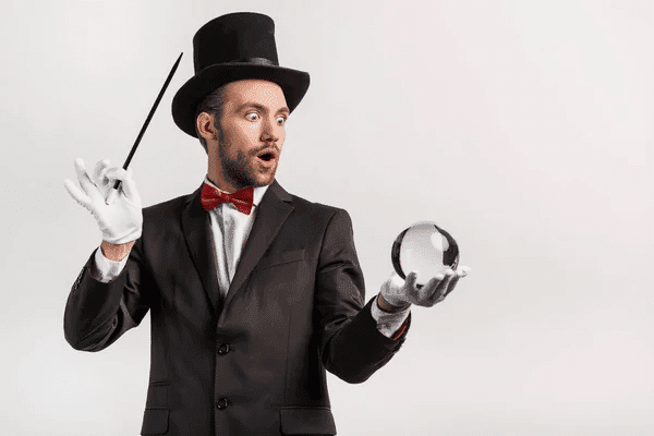 A man in a top hat and bow tie holds a glass ball, exuding a sense of magic and wonder.