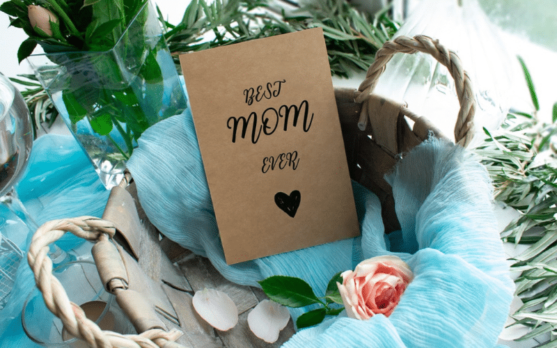 A colorful card that reads "Best Mom Ever" in bold letters, surrounded by decorative hearts and flowers.