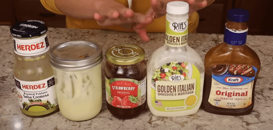 A woman presents a bottle of salad dressing, highlighting the idea of utilizing every ingredient to its fullest potential.