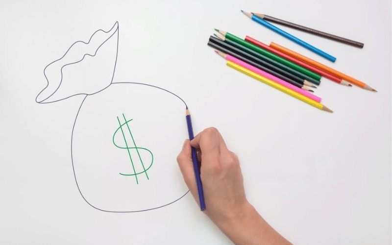 A hand holding a pencil, sketching a dollar sign on a whiteboard, symbolizing money or finance.