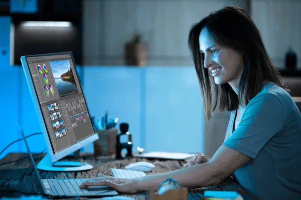 A woman working late at night on a computer, embodying the essence of a dedicated corporate sidekick.