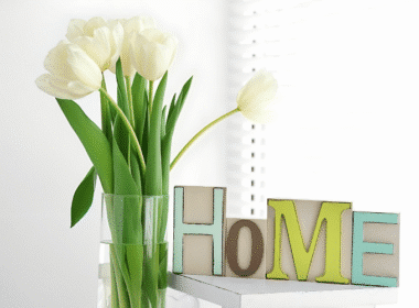 Home decor featuring vibrant tulips alongside wooden letters, promoting a cozy and inviting atmosphere.