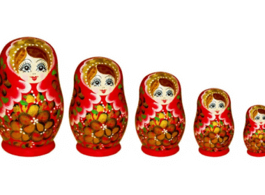 A colorful set of four Russian nesting dolls, each smaller doll fitting inside the next, showcasing traditional designs.