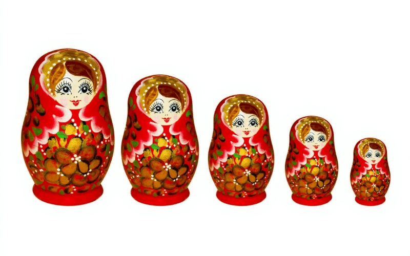 A colorful set of four Russian nesting dolls, each smaller doll fitting inside the next, showcasing traditional designs.