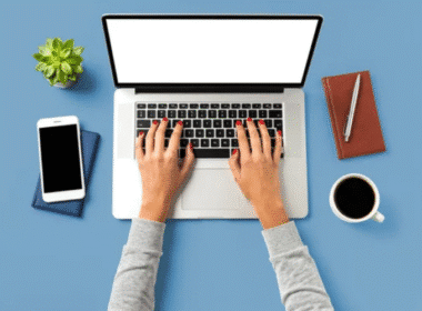 Top view of a woman's hands typing on a laptop with a blank screen, suggesting opportunities for fast typers.