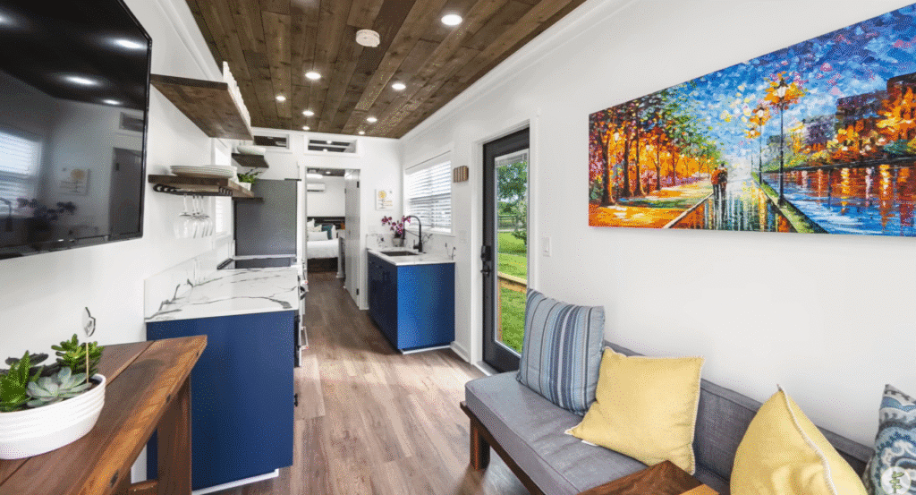 A cozy tiny home layout with a functional kitchen, a warm living room, and a dining area for shared meals.