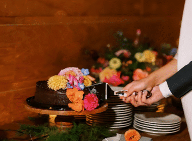 A bride and groom joyfully cutting a chocolate cake, showcasing the popular Costco Wedding Cake Hack.