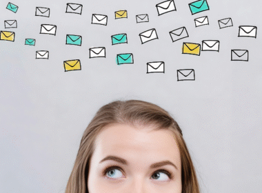 A woman gazes upward with email icons floating above her head, promoting the idea of getting paid to read emails.