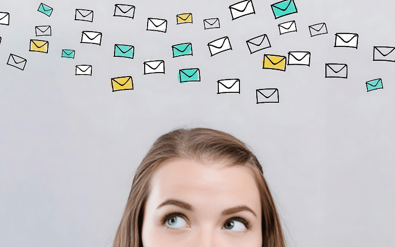 A woman gazes upward with email icons floating above her head, promoting the idea of getting paid to read emails.