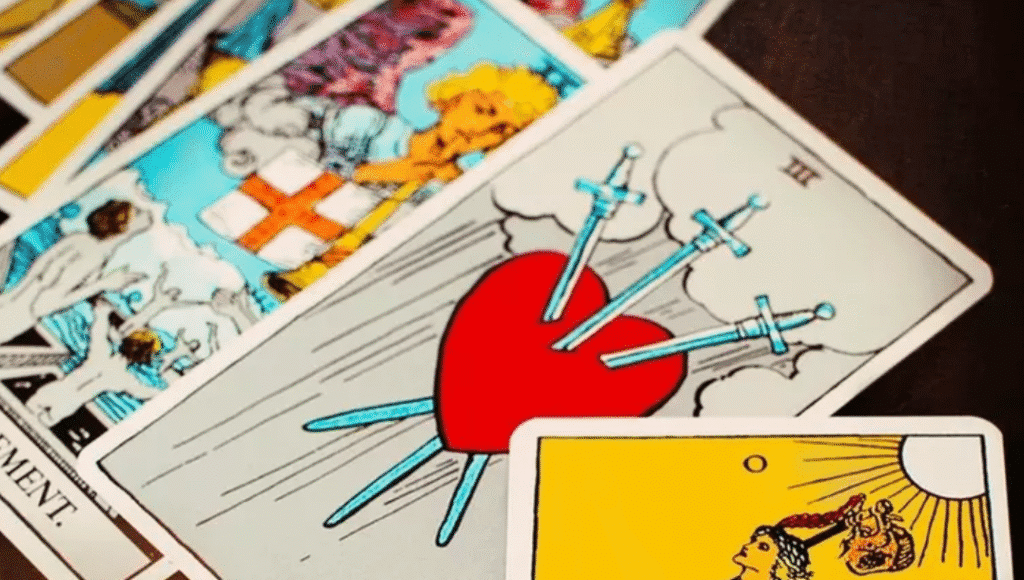 A tarot card featuring a heart and a sword, symbolizing love and conflict or duality in relationships.