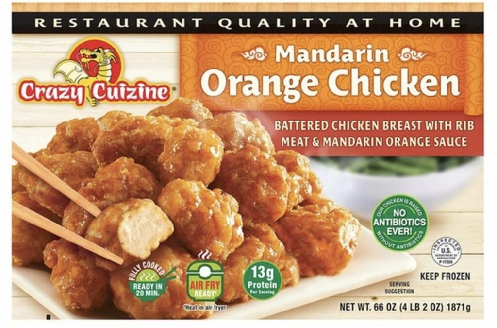A box of food on a plate featuring battered chicken breast with mandarin orange sauce, including nutritional information and cooking instructions.