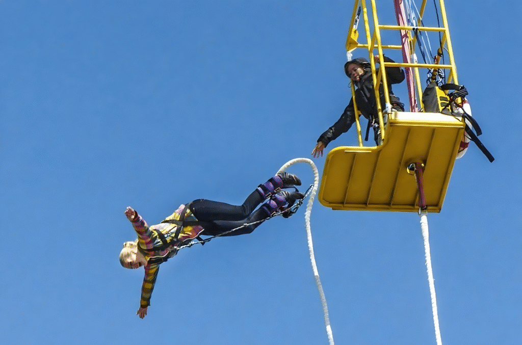 A woman is suspended from a parachute by a rope, illustrating an adventurous theme for a budget-friendly 18th birthday party.