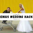 A bride and groom joyfully push a shopping cart labeled "Genius Wedding Hacks" during their wedding planning.
