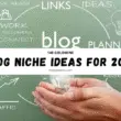 Hands holding a glowing light bulb with brainstorming words like links, ideas, and creativity in background suggesting blog niche ideas for 2026.
