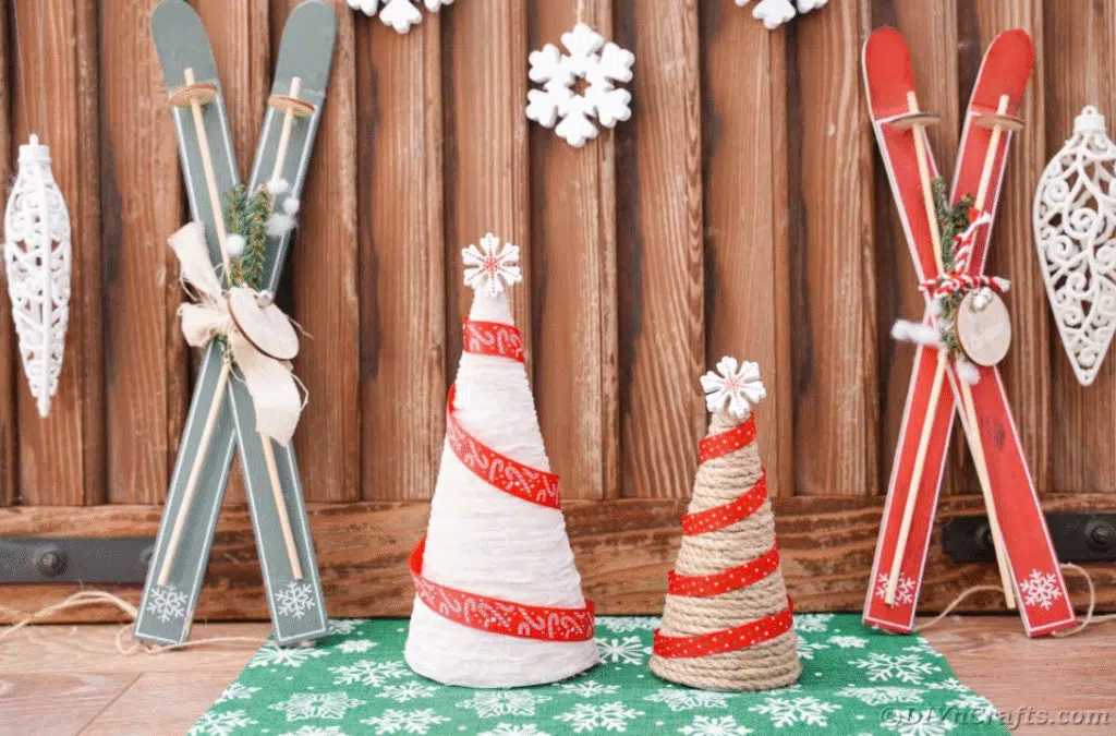 On a table, a pair of skis and snowflakes are displayed alongside mini Christmas trees, evoking a holiday atmosphere.