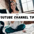 Smiling female YouTuber sitting on her bed with a camera and laptop, banner text saying Top 8 YouTube Channel Tips For Beginners.