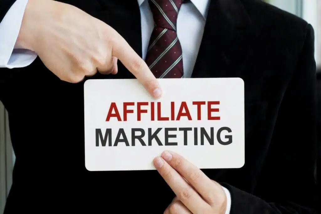 Person in business attire holding a sign that says ‘Affiliate Marketing,’ representing affiliate marketing as one of the Good Side Hustles for Women.