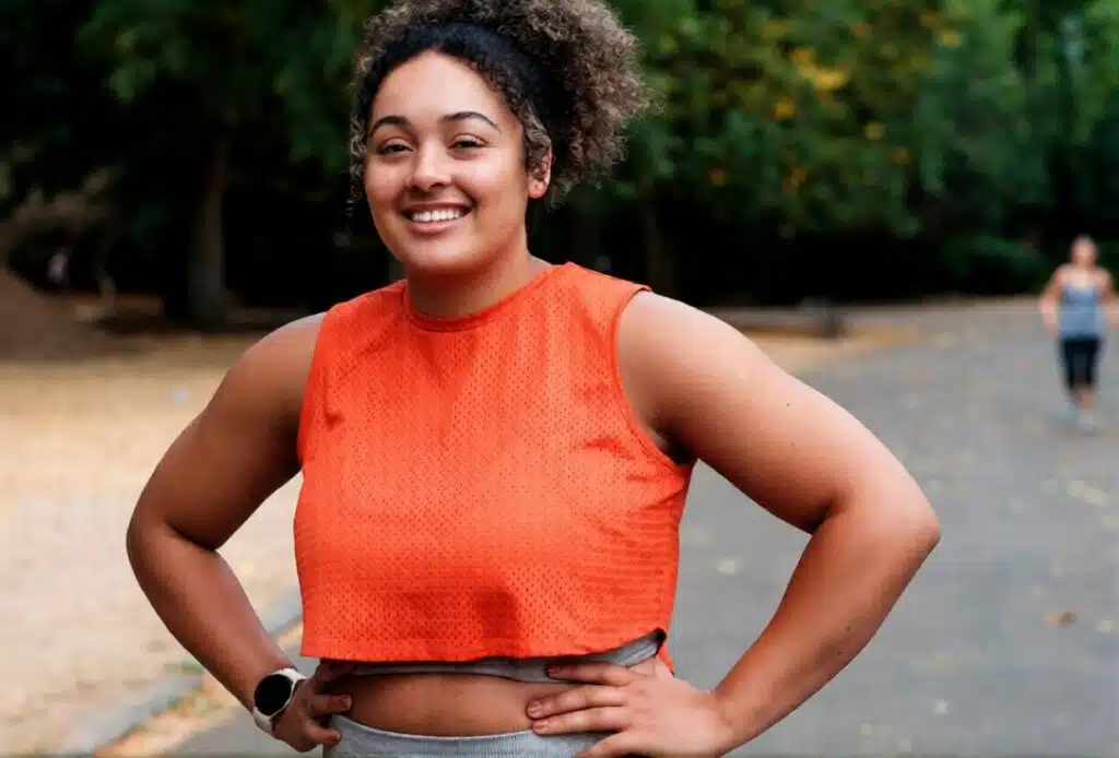Smiling woman enjoying an outdoor workout, one of the healthiest No Spend Weekend Ideas that boosts energy without spending money.