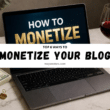 laptop on desk showing how to monetize a blog with money, showcasing behind wine glass, and workspace setup.