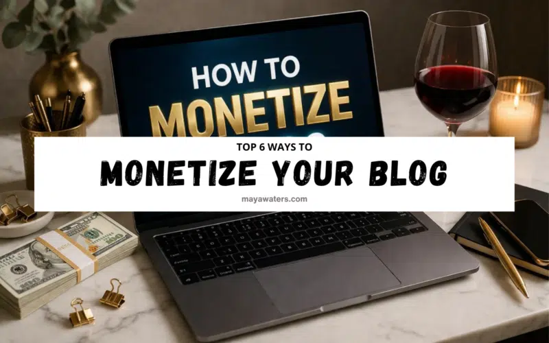 laptop on desk showing how to monetize a blog with money, showcasing behind wine glass, and workspace setup.