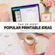 Woman creating printable planner templates on laptop with coffee, flowers and pink stationery suggesting popular printable ideas