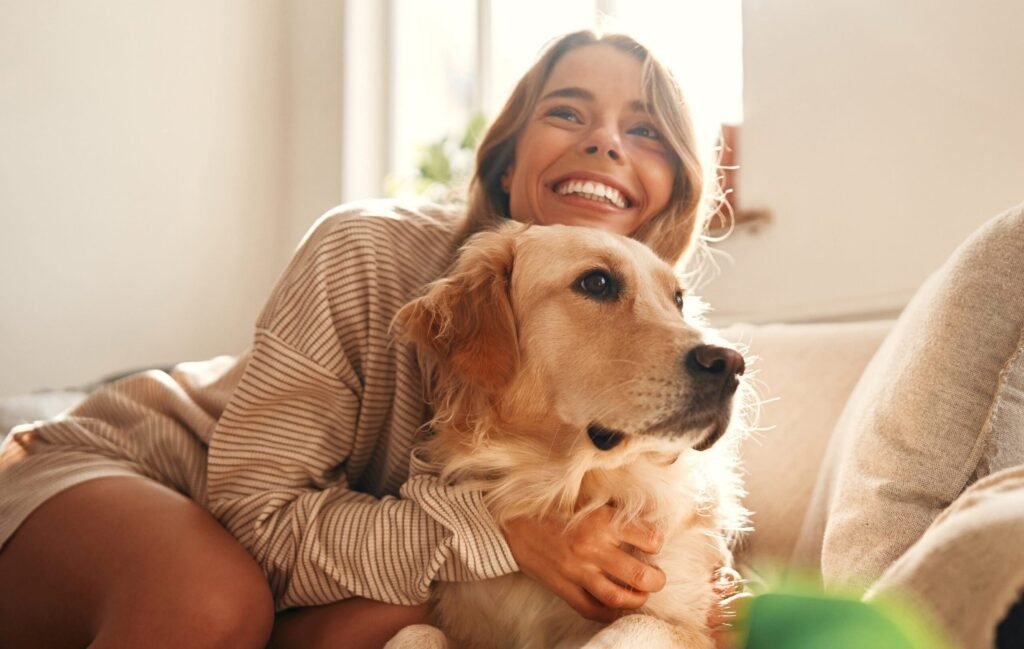 Woman hugging a dog at home for a section about creating a pet sitting flyer that gets calls.